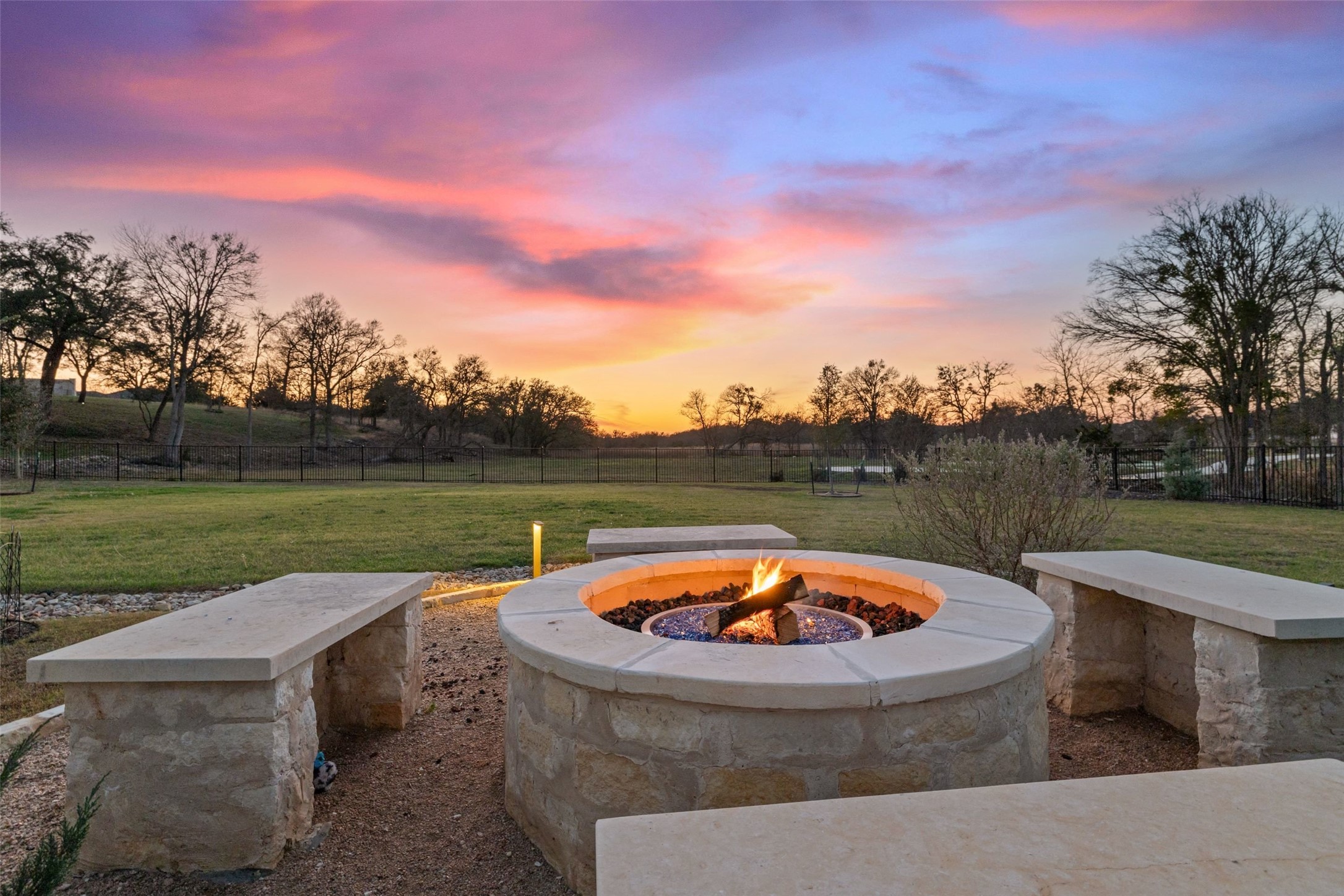 105 Deer Valley Road Georgetown, TX 78628 - Photo 39 of 40 Yard at dusk with an outdoor fire pit, a patio, and a view of rural / pastoral area