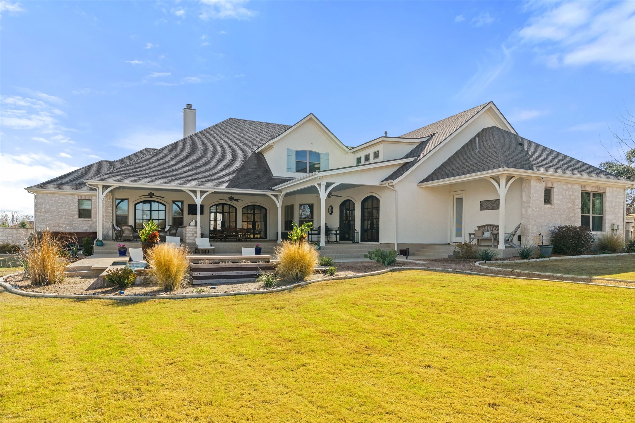 105 Deer Valley Road Georgetown, TX 78628 - Photo 5 of 40 Rear view of property with a chimney, a lawn, and stucco siding