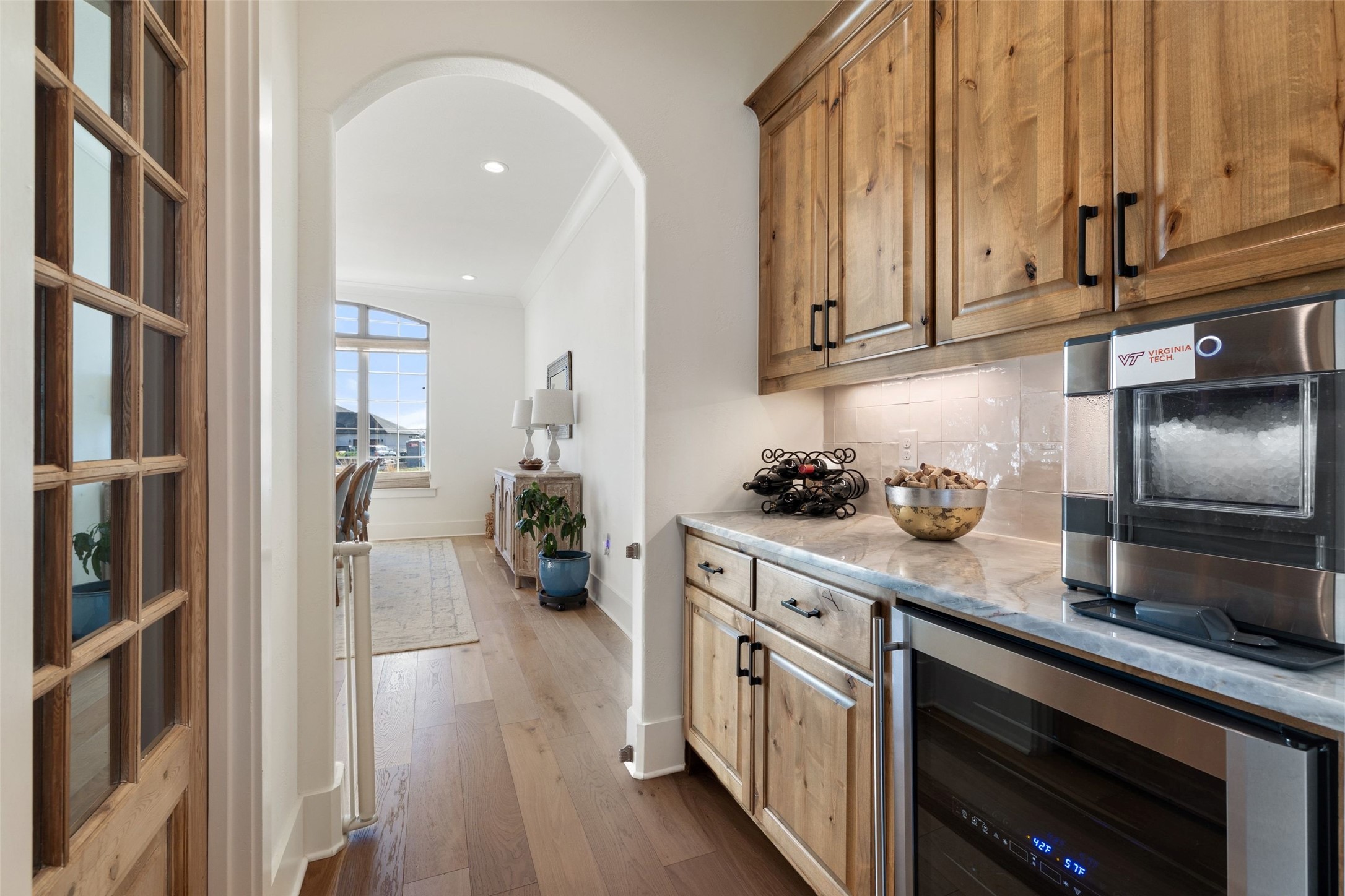 105 Deer Valley Road Georgetown, TX 78628 - Photo 10 of 40 Bar featuring arched walkways, wine cooler, dark wood-type flooring, tasteful backsplash, and recessed lighting