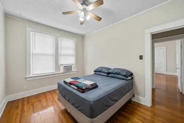a living room with furniture a dining table and a wooden floor