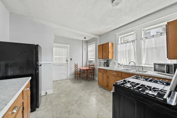 a bathroom with a granite countertop sink and a window