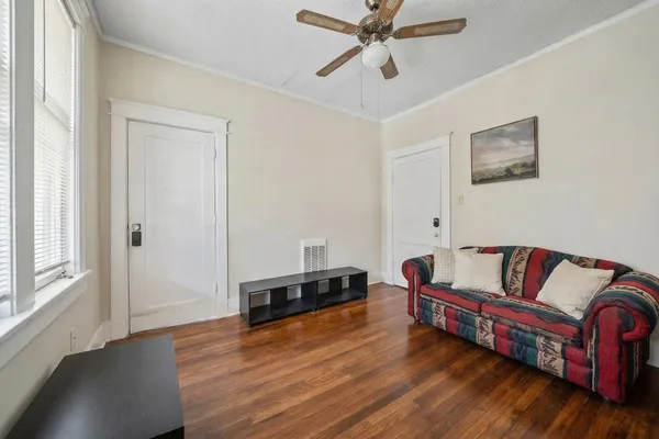 a bedroom with a bed and wooden floor