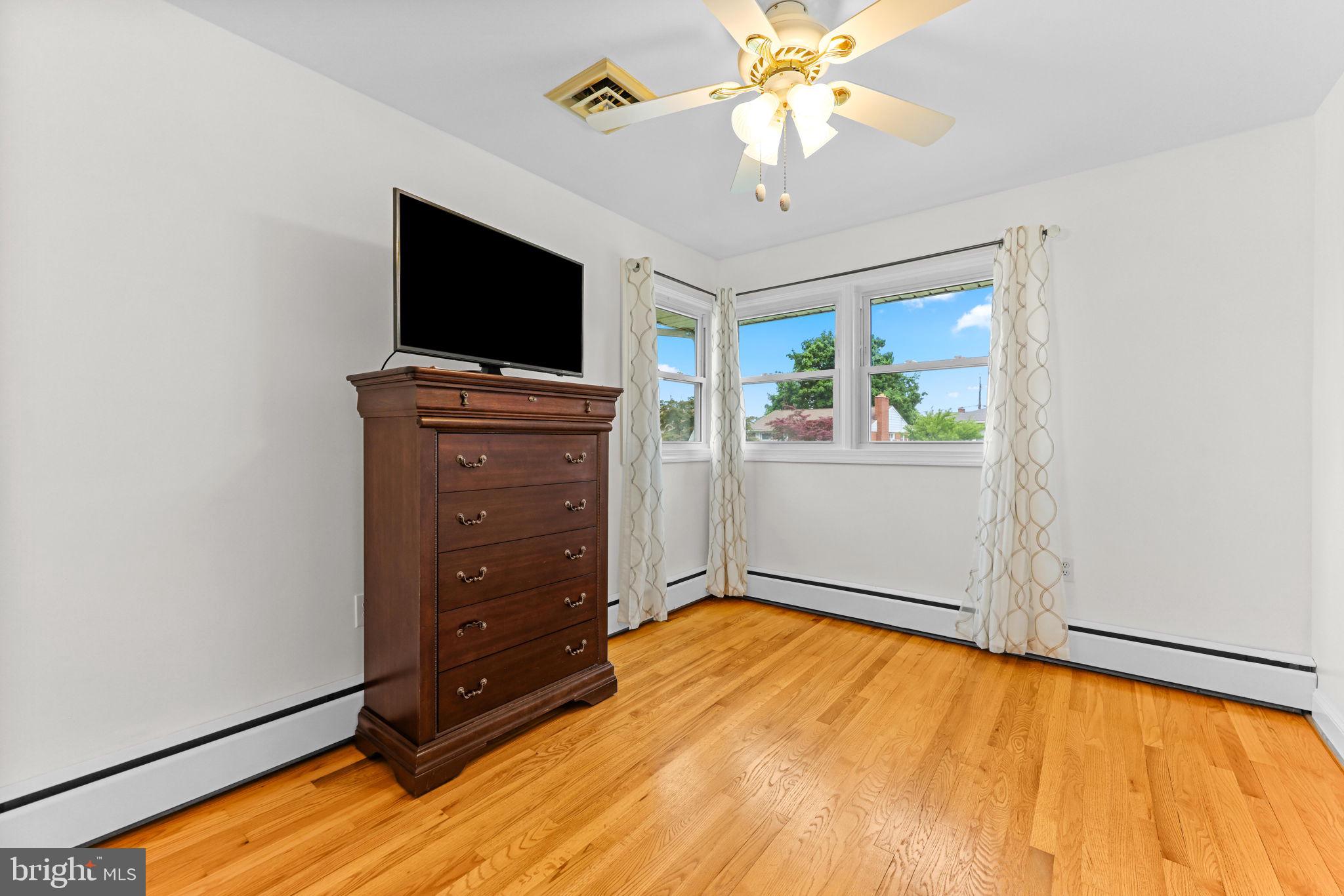 2902 Ritchie Avenue Baltimore, MD 21219 - Photo 22 of 43 a view of a room with cabinet flat screen tv and windows