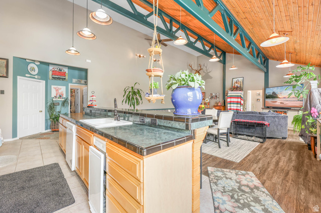 569 Elk Meadow Loop Tooele, UT 84074 - Photo 55 of 56 Kitchen with pendant lighting, a vaulted wooden ceiling, open floor plan, white dishwasher, and a kitchen breakfast bar