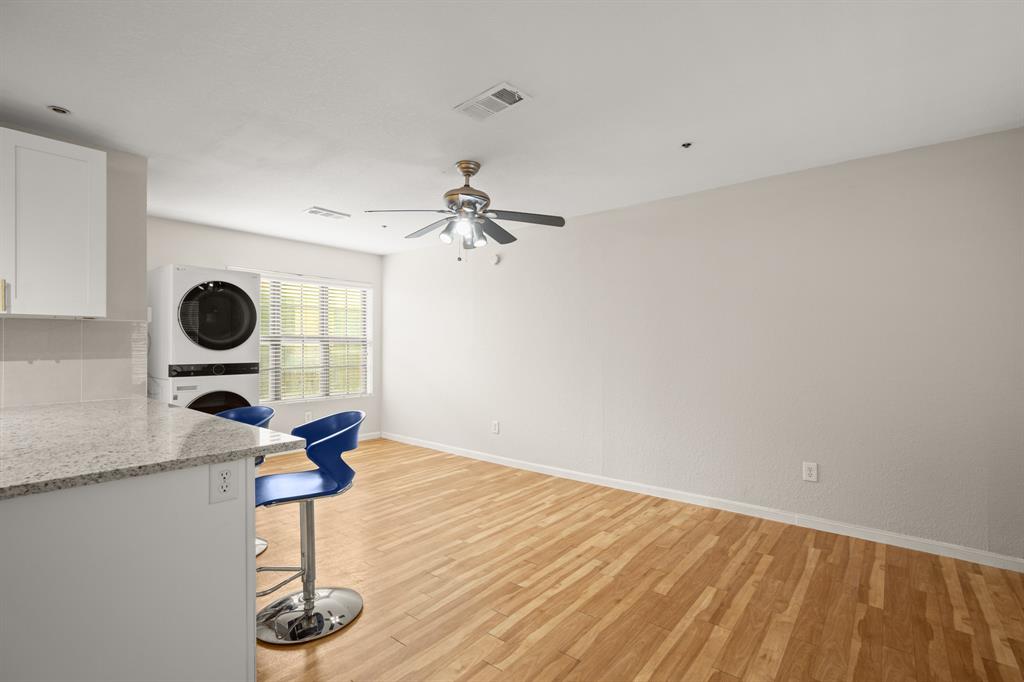 1013 West 23rd Street, Unit 104 Austin, TX 78705 - Photo 4 of 11 view to the rest of the living space with a big window for natural light.
