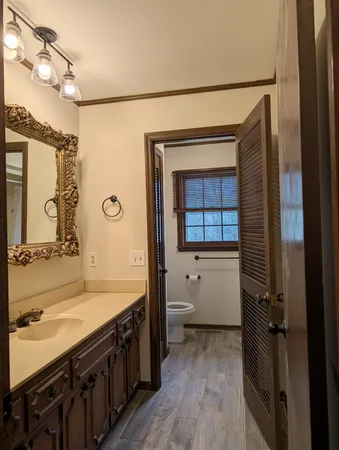 a bathroom with a double vanity sink a mirror and a bathtub
