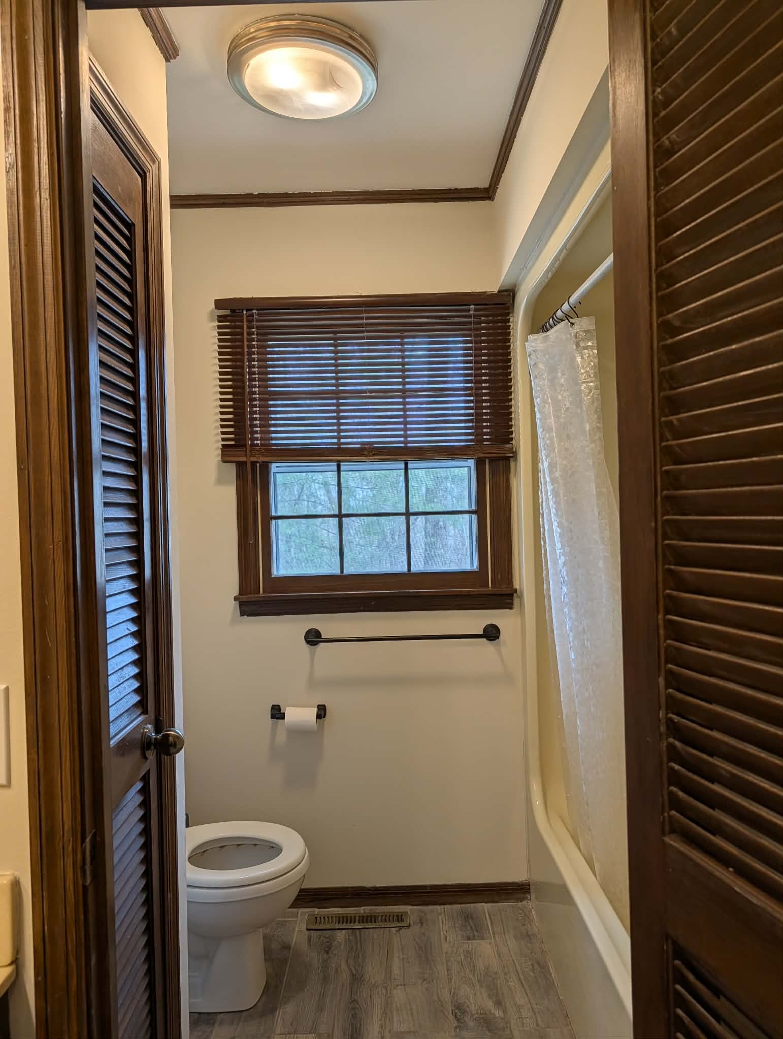 1581 Galen Road Lafayette, TN 37083 - Photo 25 of 36 a bathroom with a toilet and a shower curtain