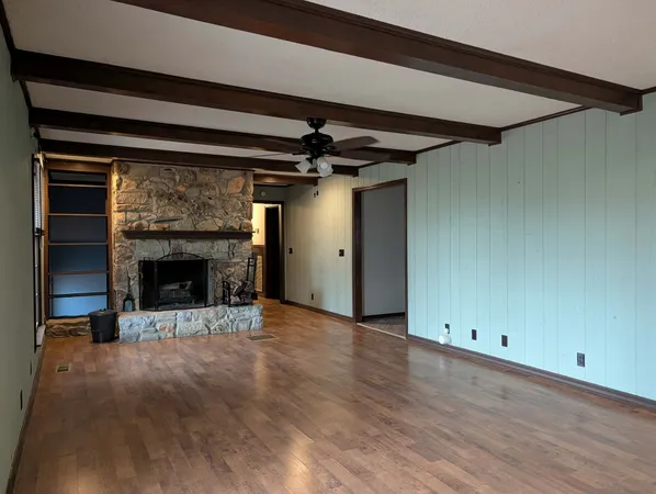 a view of a livingroom with a fireplace and chandelier