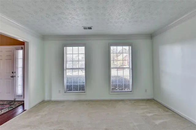 a kitchen with stainless steel appliances granite countertop a refrigerator a sink a stove a microwave and wooden cabinets