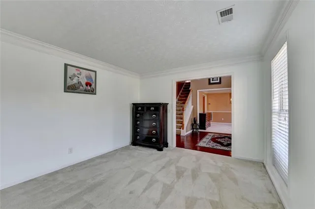 a view of a dining room with furniture and window