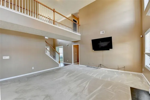 a bedroom with a bed and a lamp on dresser