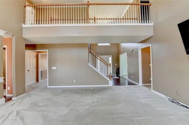 a bathroom with a granite countertop sink a toilet a mirror and shower curtain