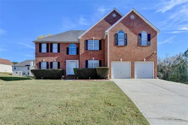 a front view of a house with yard