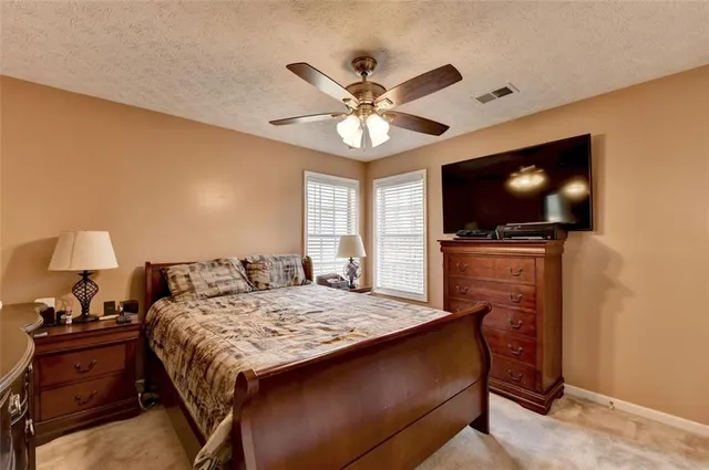 a kitchen with stainless steel appliances granite countertop a stove top oven a sink dishwasher a dining table and chairs with wooden floor