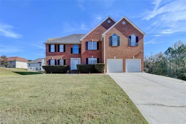 a front view of a house with a yard