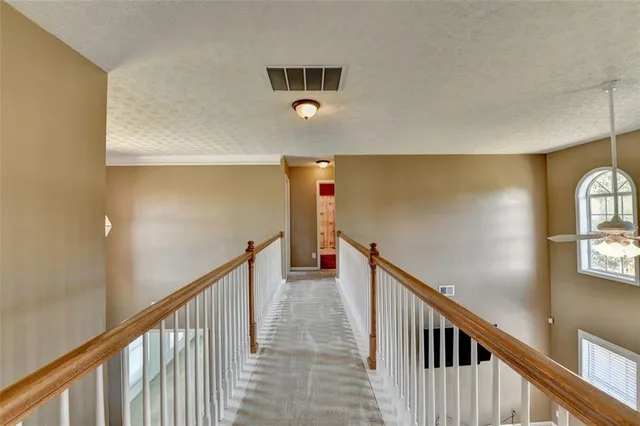 a bathroom with a granite countertop toilet sink and mirror