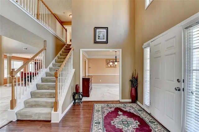 a view of an empty room with a window and a flat screen tv
