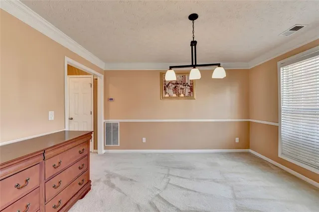 a view of a livingroom with an empty space and a flat screen tv