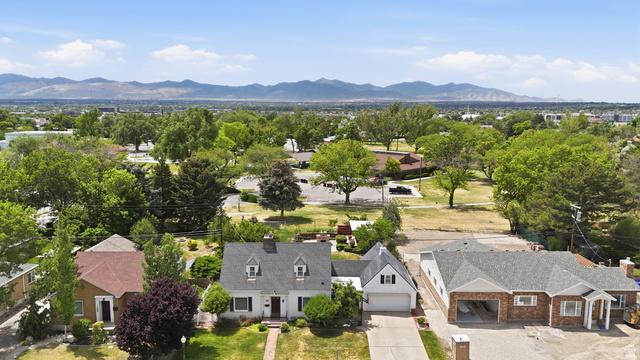 7576 South Jefferson Street Midvale, UT 84047 - Photo 49 of 53 Charming two-story residence featuring a prominent front gable, dormer windows, and a white exterior with dark shutters