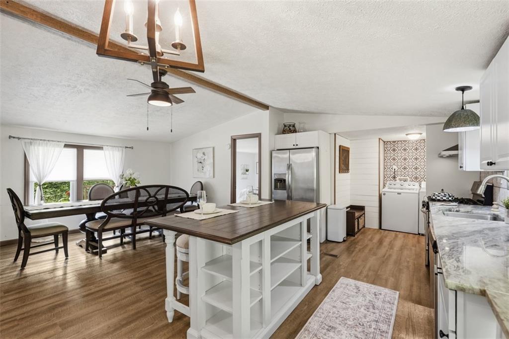 8517 Wittmer Road Pittsburgh, PA 15237 - Photo 4 of 46 a kitchen with a table chairs stove and wooden floor