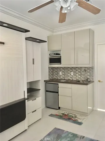 a kitchen with stainless steel appliances kitchen island granite countertop a sink and cabinets