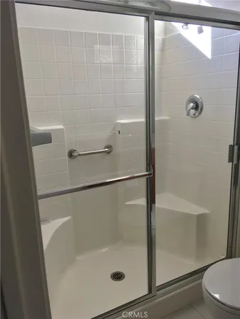 a bathroom with a glass shower door