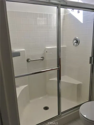 a bathroom with a glass shower door