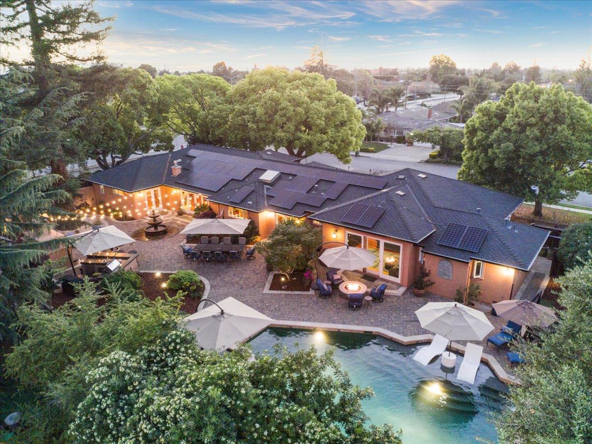 an aerial view of a house with a yard basket ball court and outdoor seating