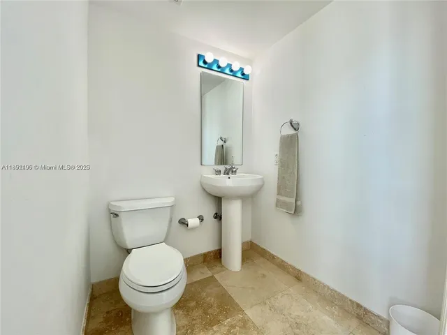 a bathroom with a sink a toilet and mirror
