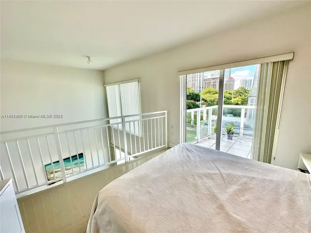 a view of a bedroom with wooden floor