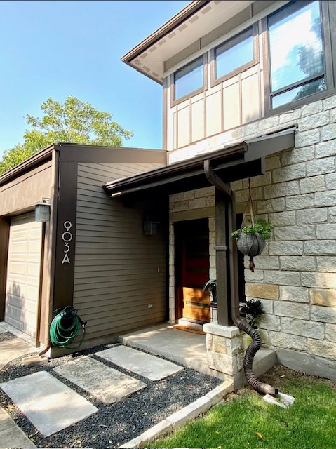 903 Cardinal Lane, Unit A Austin, TX 78704 - Photo 1 of 23 Entrance to property with stone siding and an attached garage