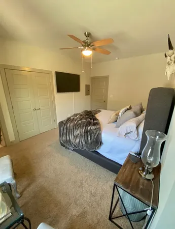 a bedroom with a bed and chair