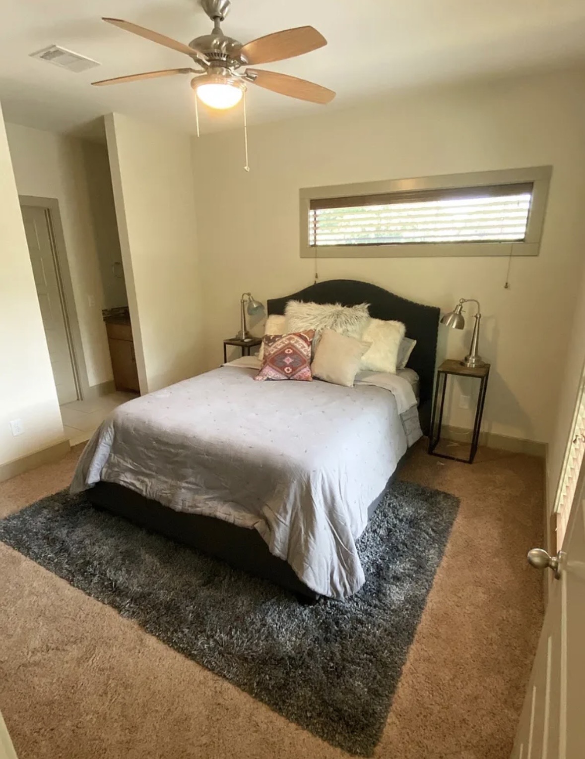 903 Cardinal Lane, Unit A Austin, TX 78704 - Photo 14 of 23 Bedroom featuring light colored carpet, ceiling fan, and ensuite bathroom
