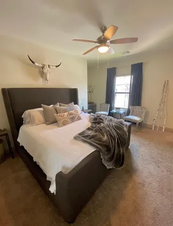 a bedroom with bed and window