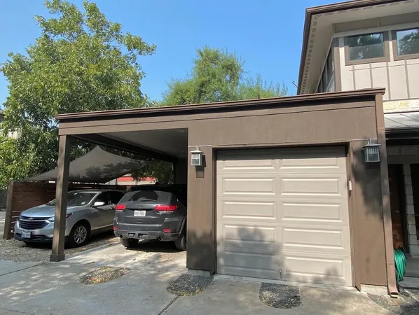a view of a car parked in back of a house