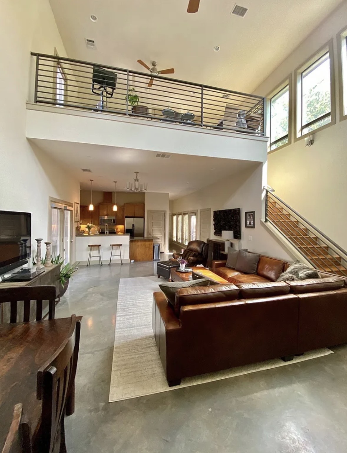 903 Cardinal Lane, Unit A Austin, TX 78704 - Photo 4 of 23 Living room with a ceiling fan, finished concrete flooring, and a high ceiling