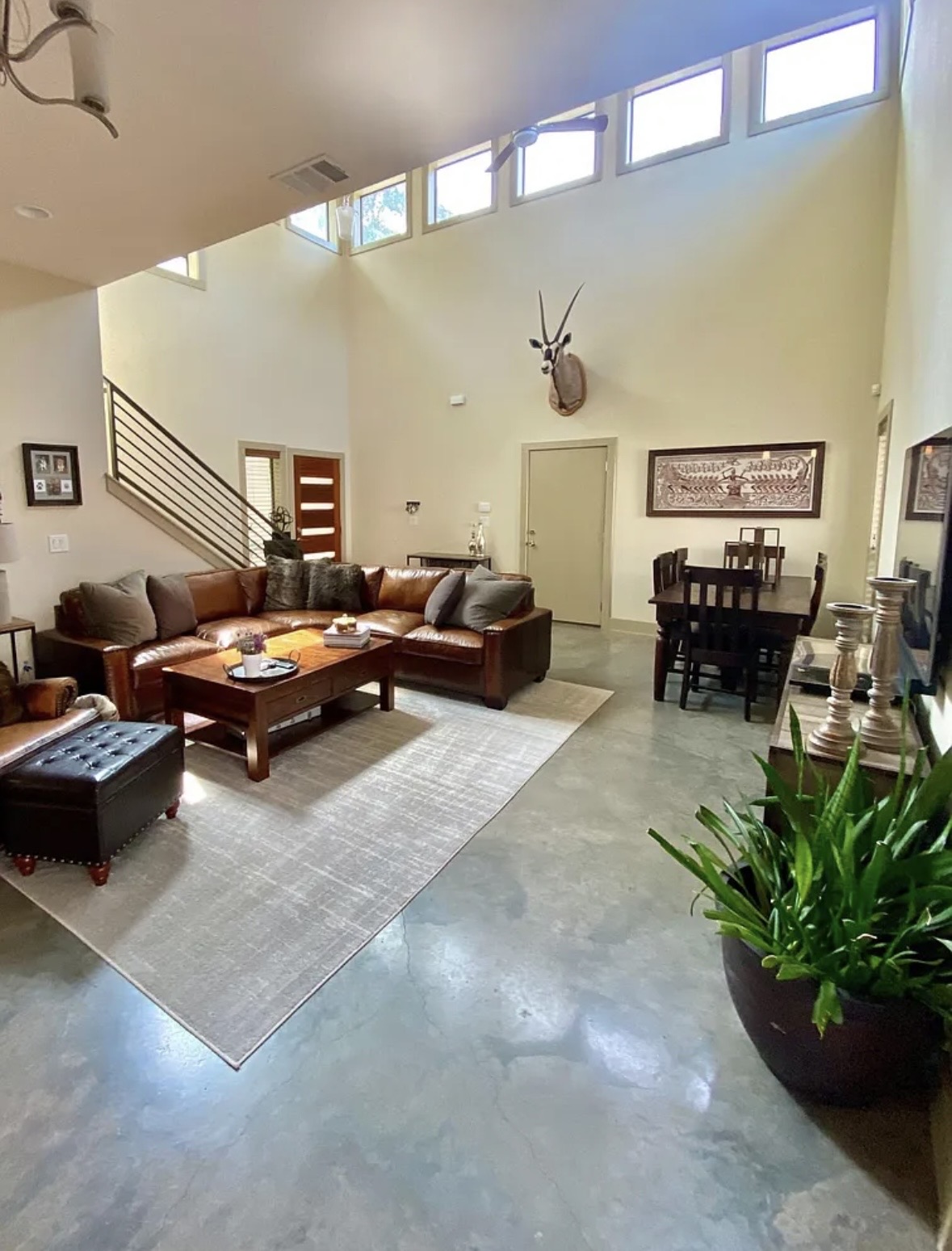 903 Cardinal Lane, Unit A Austin, TX 78704 - Photo 5 of 23 Living room featuring finished concrete flooring and a high ceiling