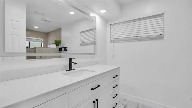 a bathroom with a toilet a sink and shower