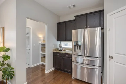 a balcony with wooden floor table and chairs