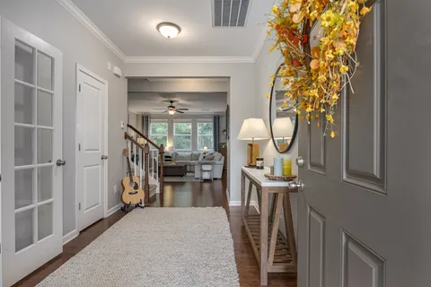 a view of a hallway with a livingroom and furniture