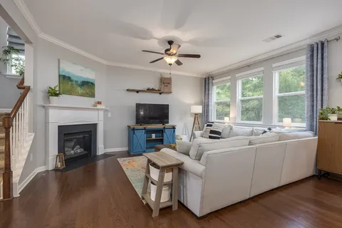 a dining room with furniture a chandelier and wooden floor