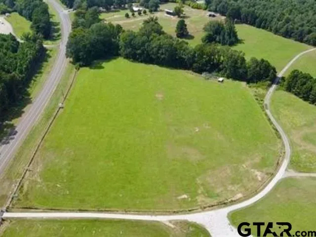 a view of a swimming pool with a yard
