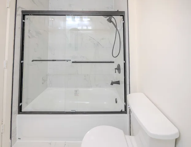 a bathroom with a shower and toilet
