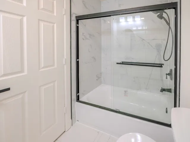 a bathroom with a bathtub and a shower