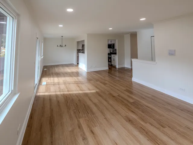 a view of an empty room and wooden floor
