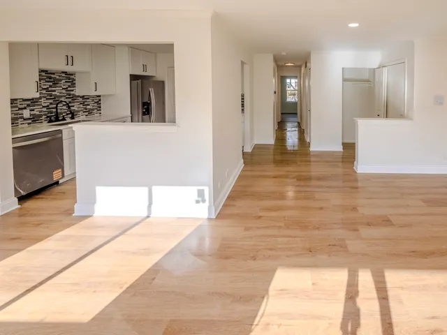 a hallway with cabinets and wooden floor