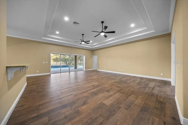 a view of livingroom with chandelier and wooden floor