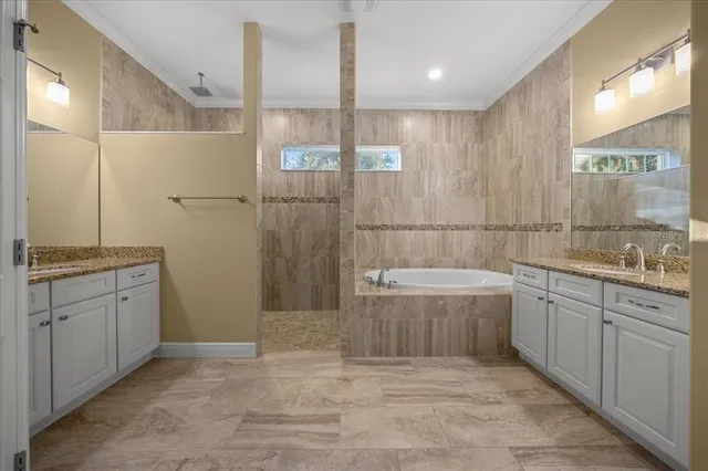 a bathroom with a granite countertop toilet a sink and shower