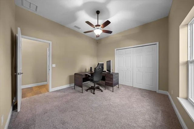 a view of a house with a big yard and large trees