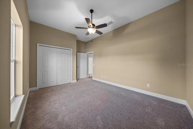 a view of a house with a yard and street